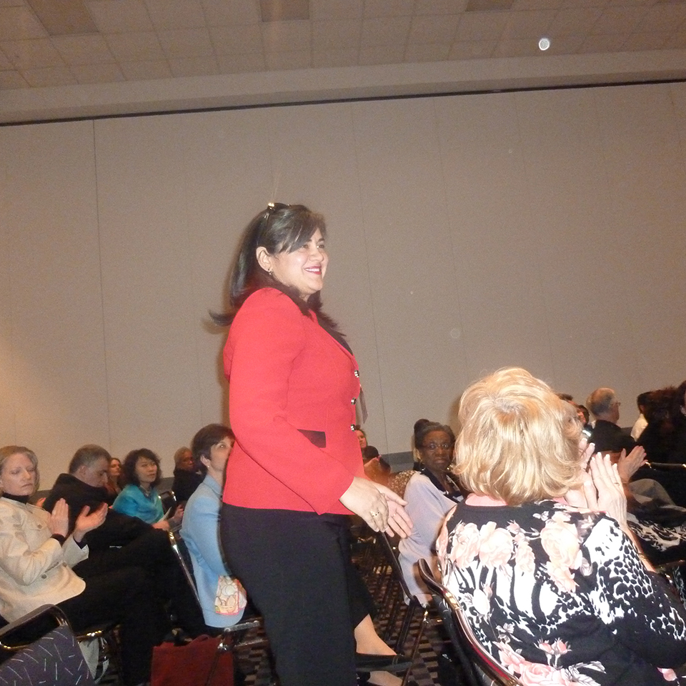 Brenda standing in the crowd as they recognize her Affirmative Action Award